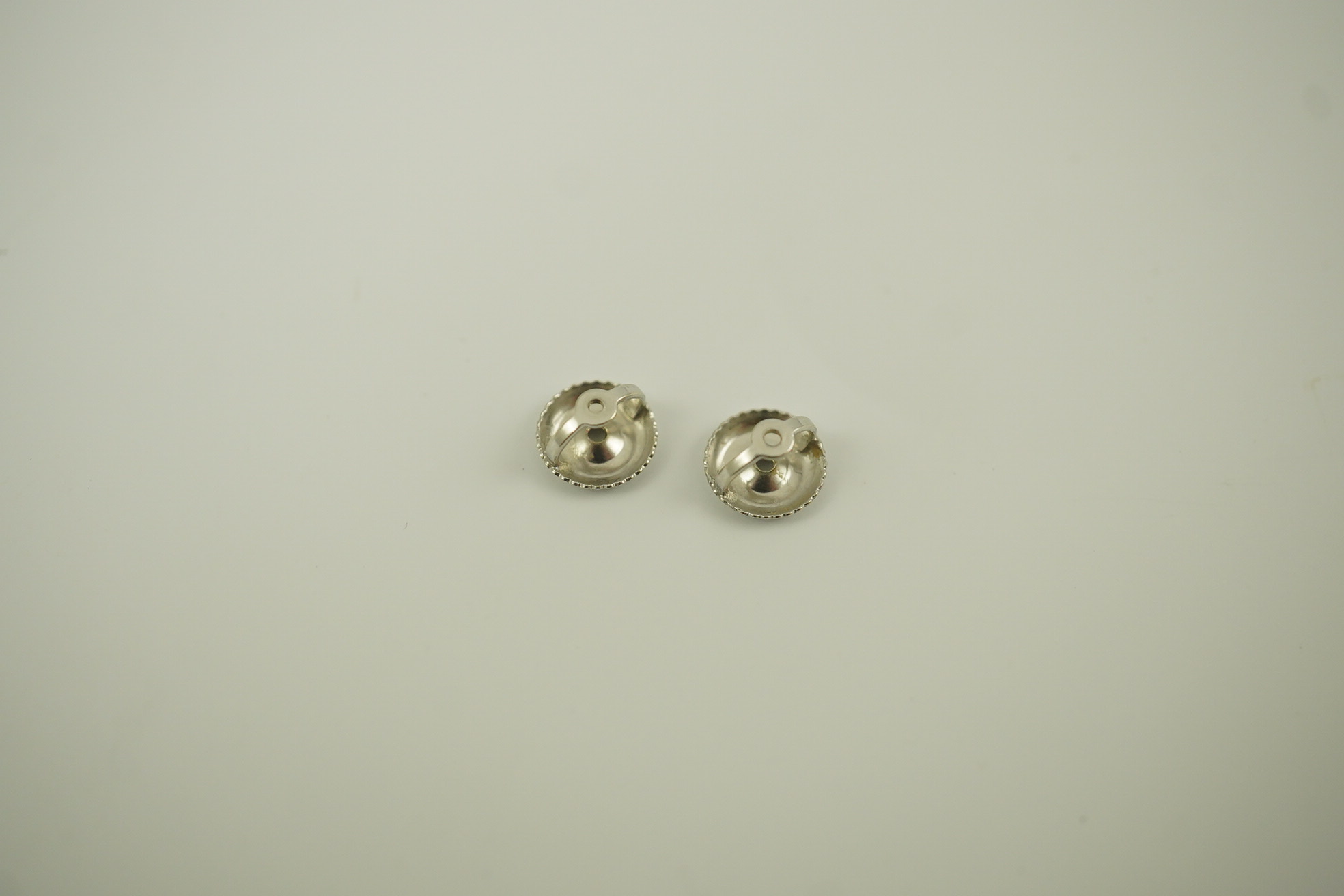 A pair of 14k white gold and solitaire diamond set ear studs